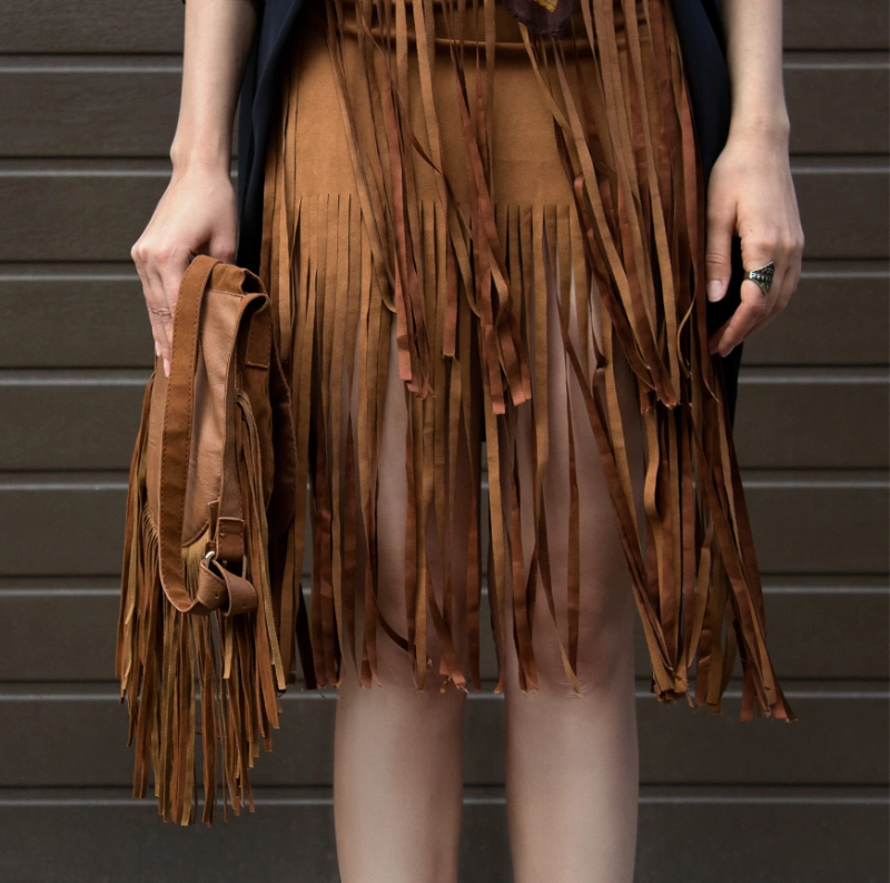 a woman with a fringe skirt and bag