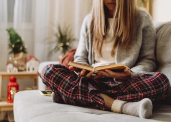 Woman reads a book in hygge style