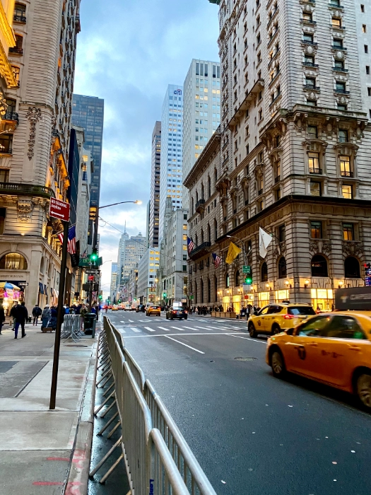 a street in new york with yellow cabs
