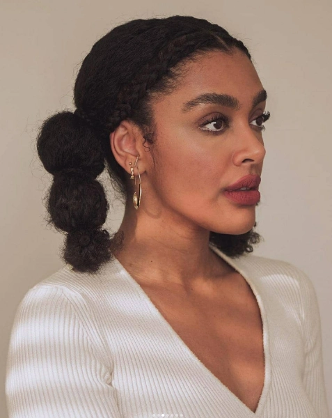 a young woman with black curly bubble braids
