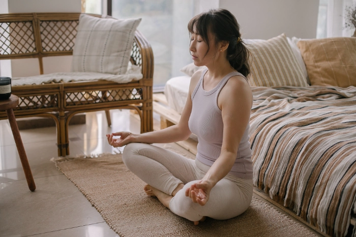 a women is meditating  sitting on the floor