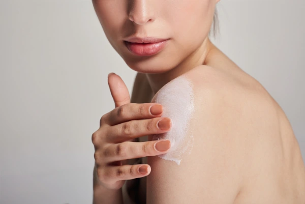 a young woman is doing her body winter skin care