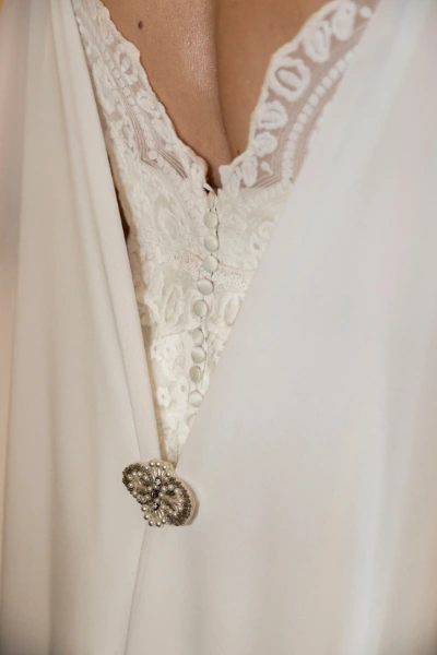 a brooche on a white dress