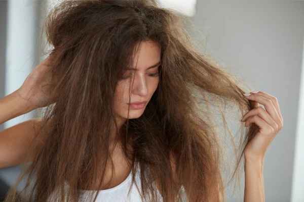 a young woman with long brown heat damaged hair