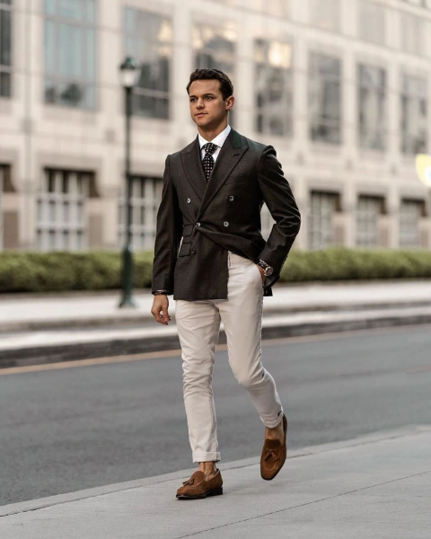 a young man in a jacket and tie wedding attire