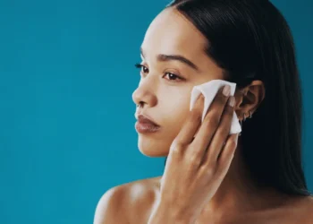 a young black haired woman doing a makeup removal