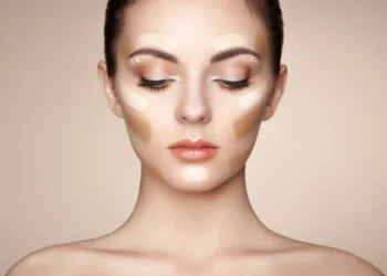 a Young woman with dark blonde hair wearing concealer - natural facelift