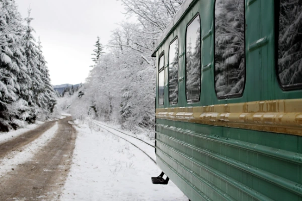 "the Polar Express" a green train running through a winter landscape