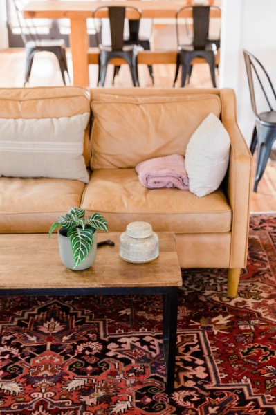 a light brown sofa and a floral textured carpet