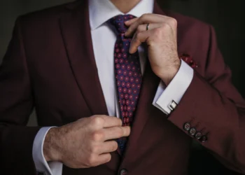 a man in a red formal wedding attire
