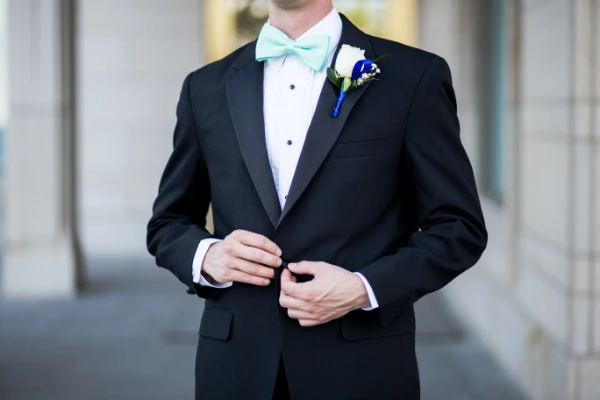 a man in a white tie wedding attire