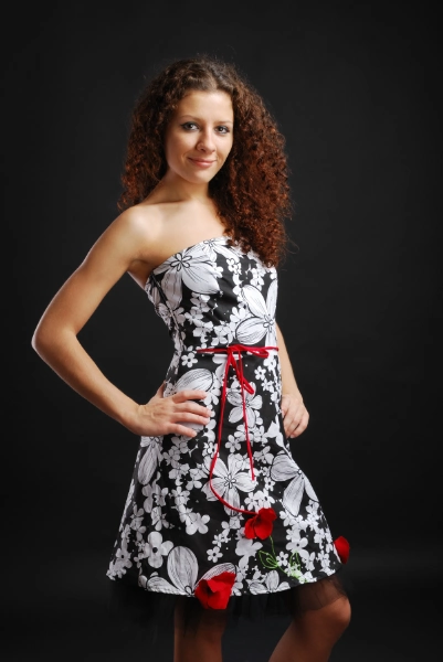 a young woman in a bright floral cocktail dress