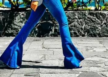 a woman walking in a flare jeans
