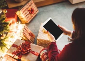 a woman is looking for last minute christmas gifts on her ipad