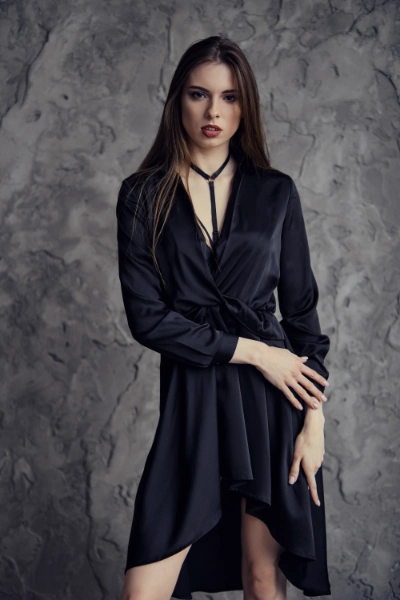 a young woman in a black silk stin dress