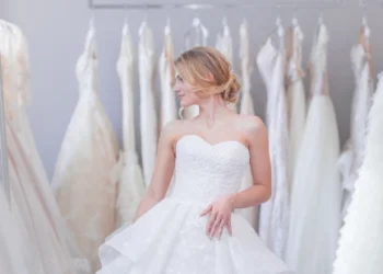 a young blonde woman in a room with the wedding dress trends